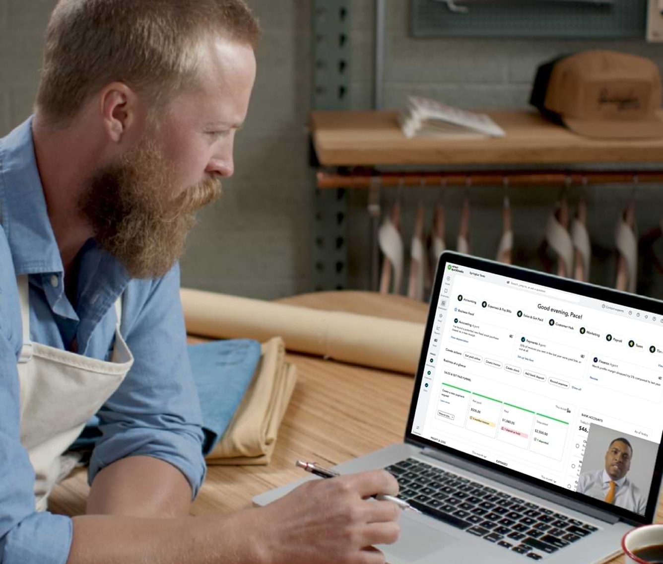 Man working on laptop in workshop setting